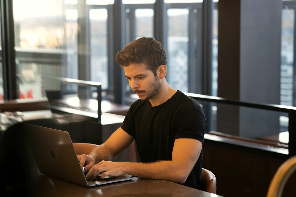 Young man concentrating on his laptop